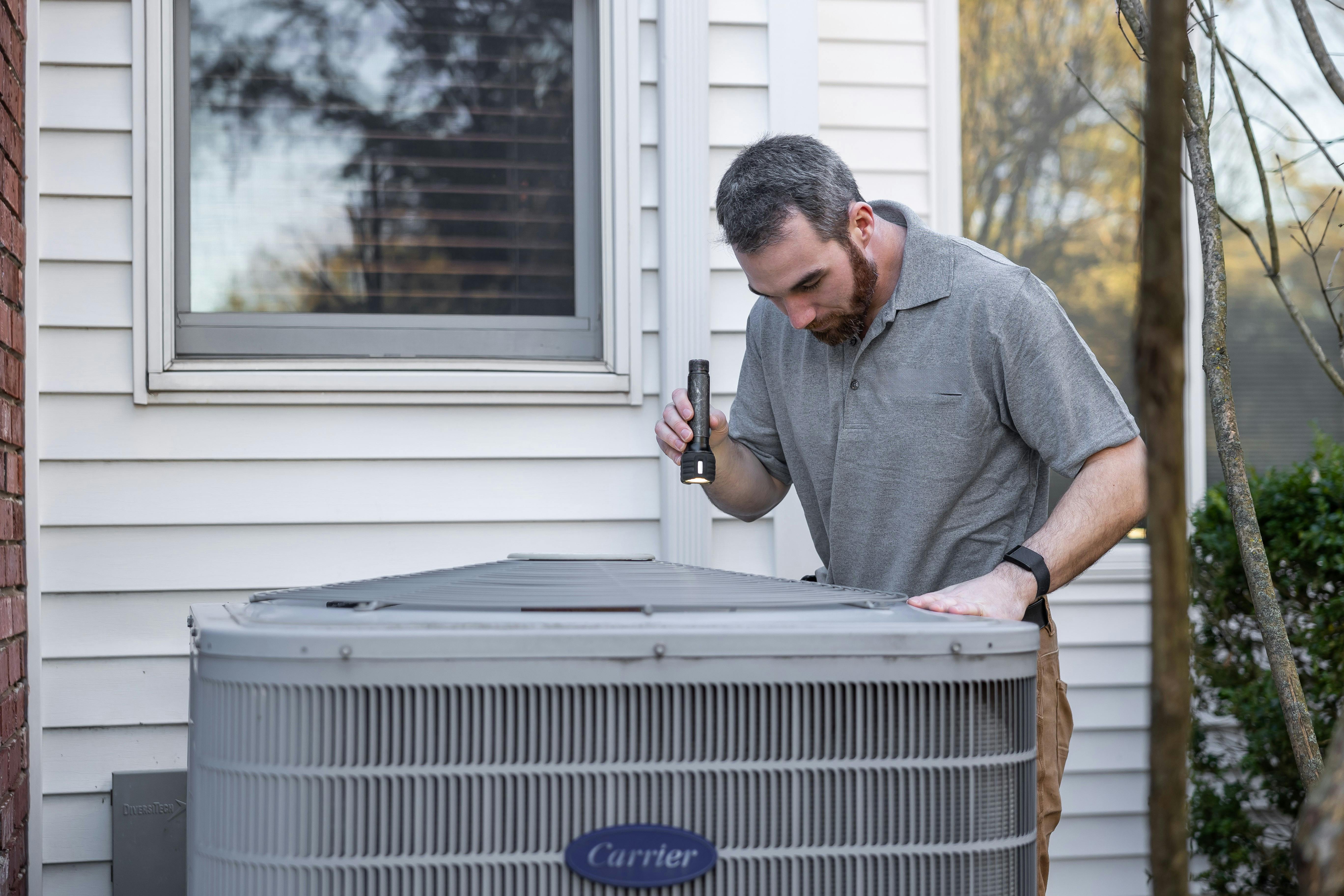 Professional HVAC technician servicing AC unit in Ocala, FL